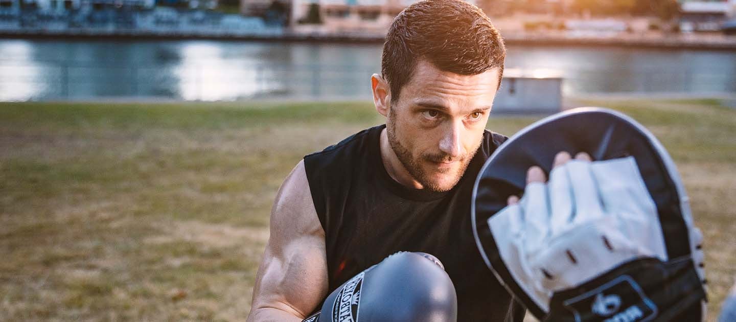 Male boxing in park