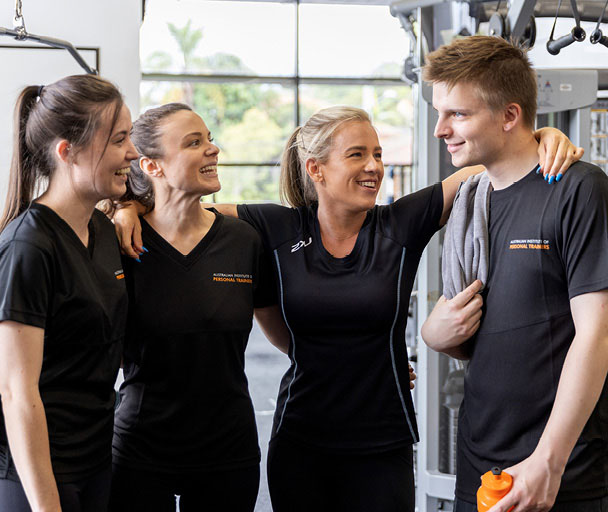 Trainer smiling with group of students