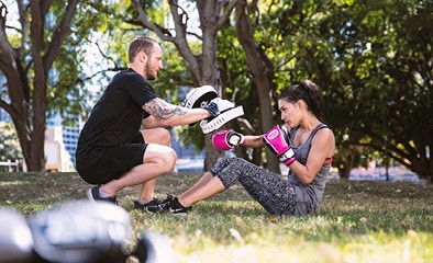 male and female boxing in park