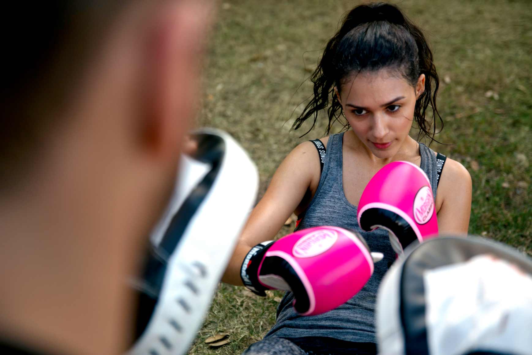 Woman boxing with Trainer