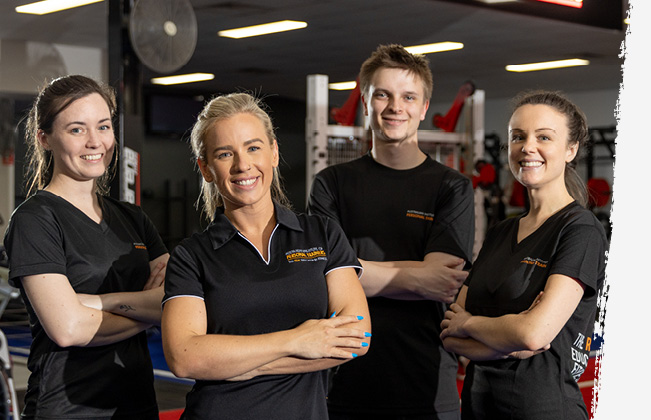 Group of people with arms crossed in gym