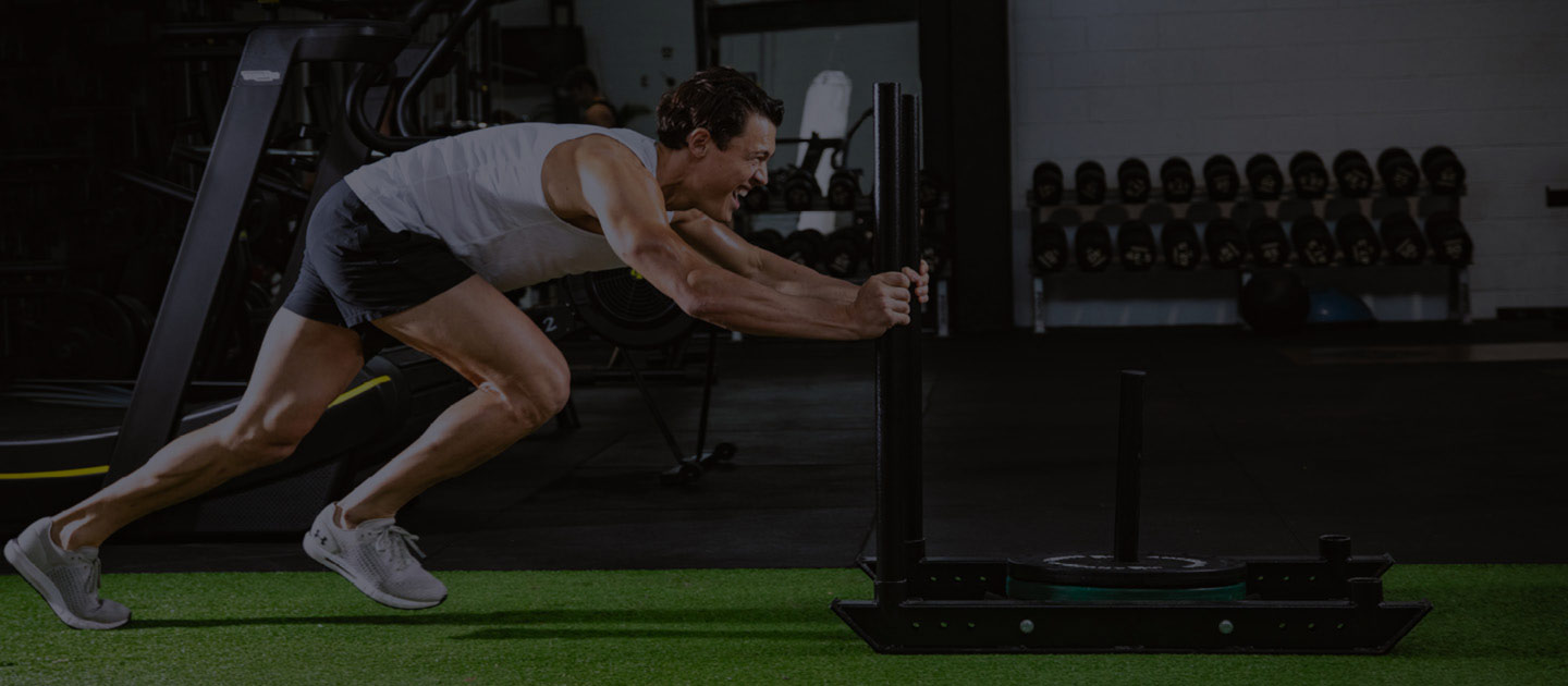 Man pushing weights inside gym