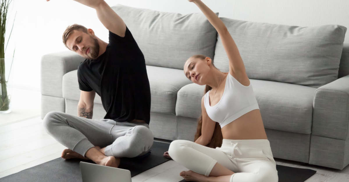 Man and women doing a seated stretch