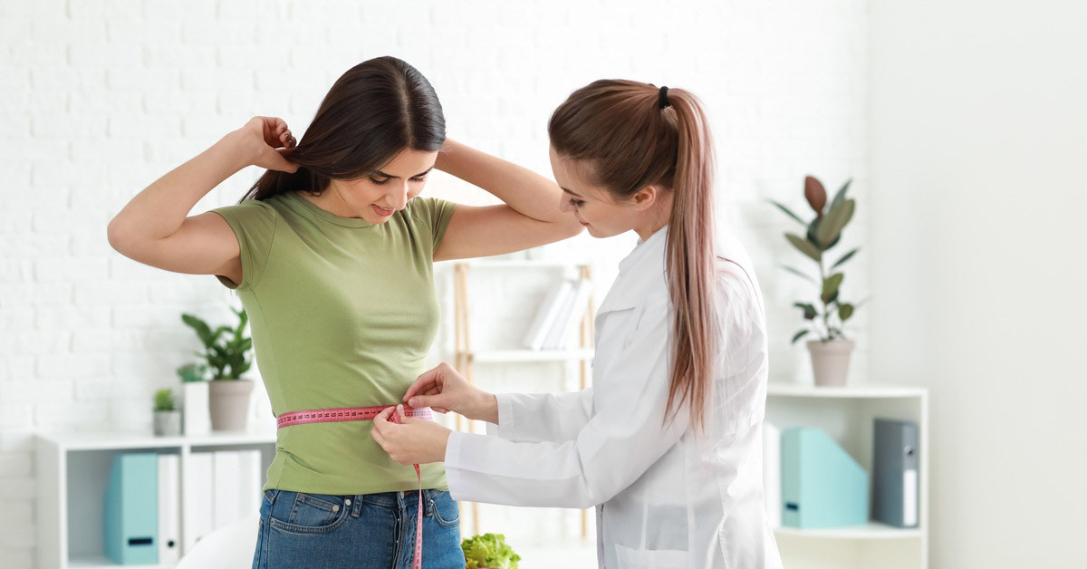 Nutritionalist measuring a client