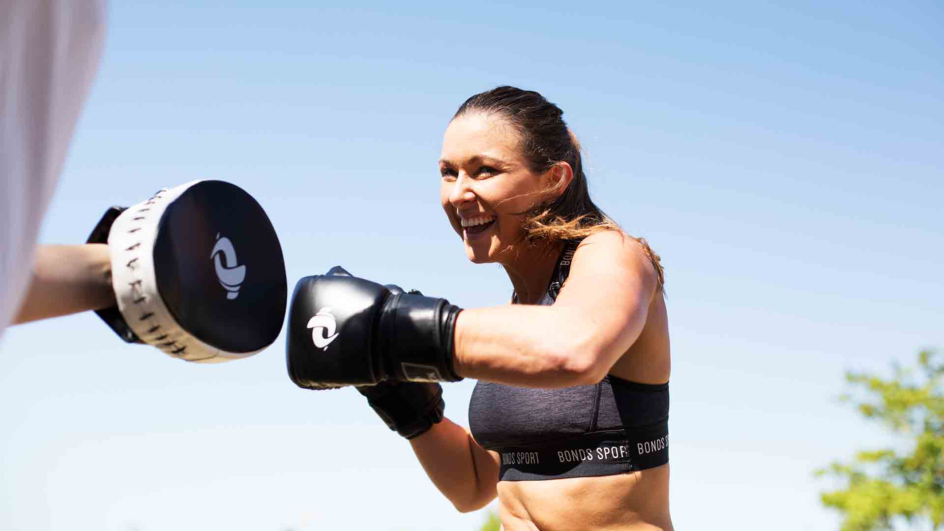 personal trainer using boxing equipment