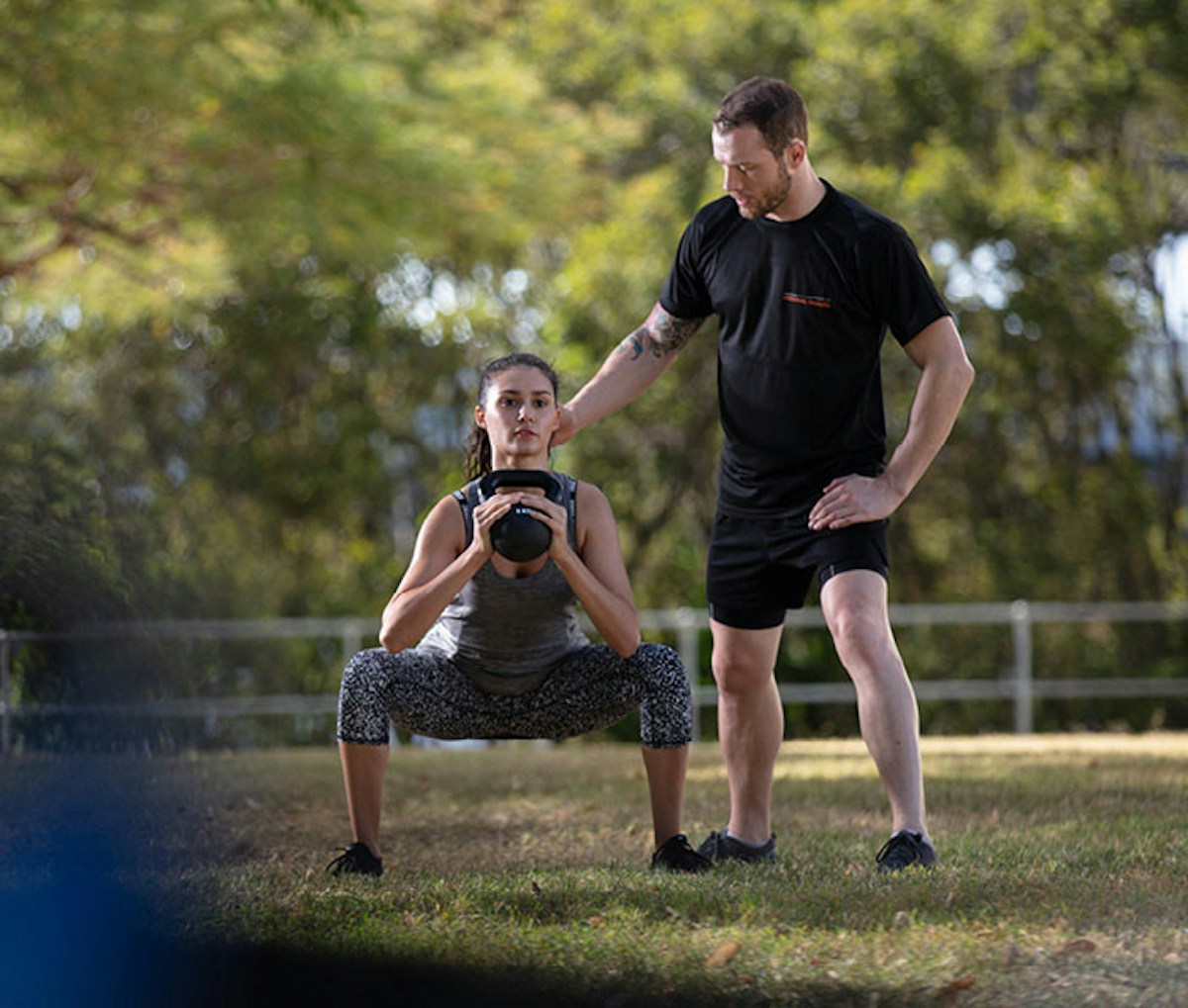 man and woman training outdoors