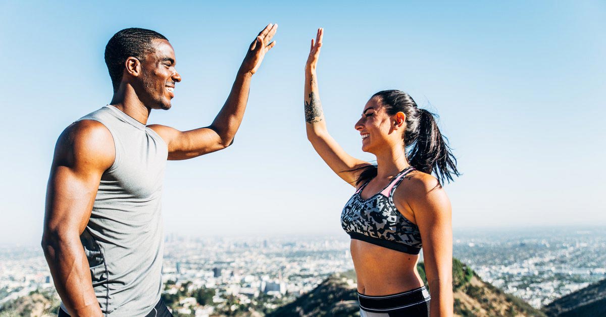 Man and woman give high five outdoors