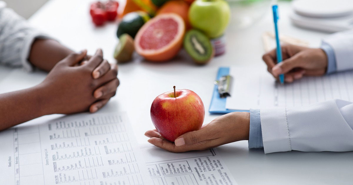 Nutritionalist holding an apple