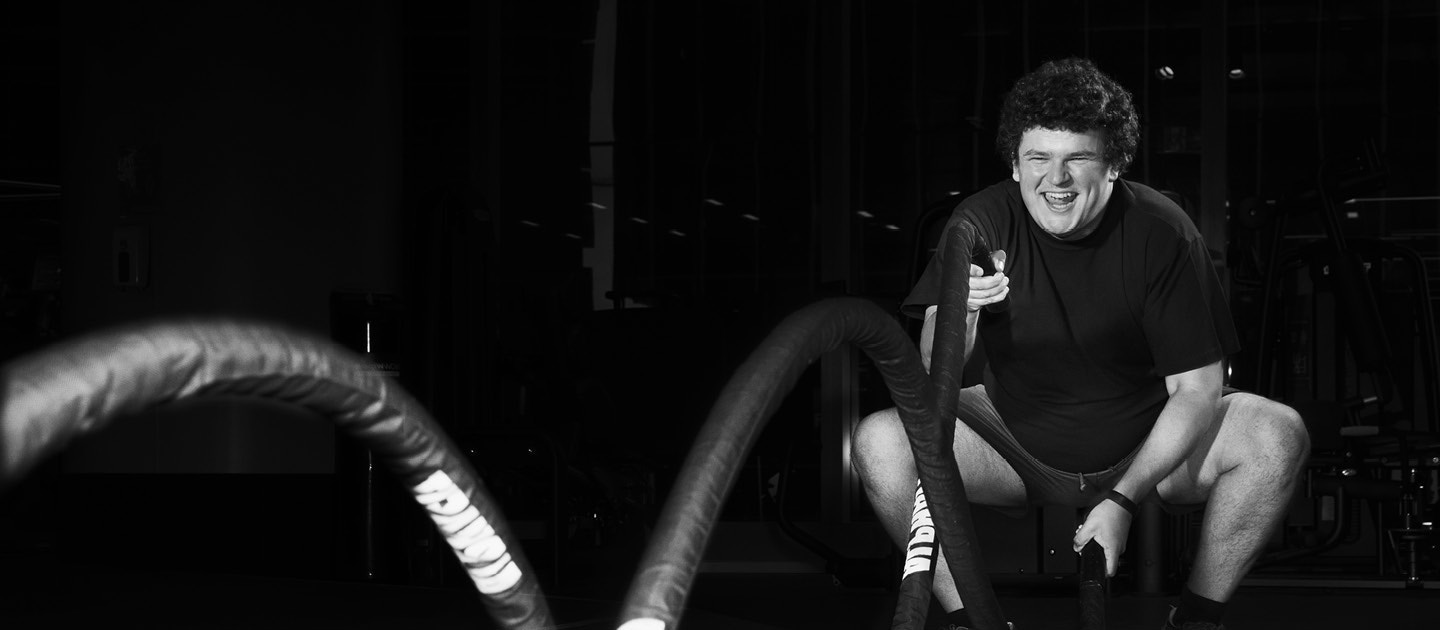 Young man using battle ropes
