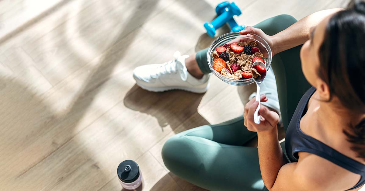 woman eating a healthy bowl of muesli