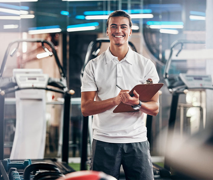 Trainer teaching client on treadmil