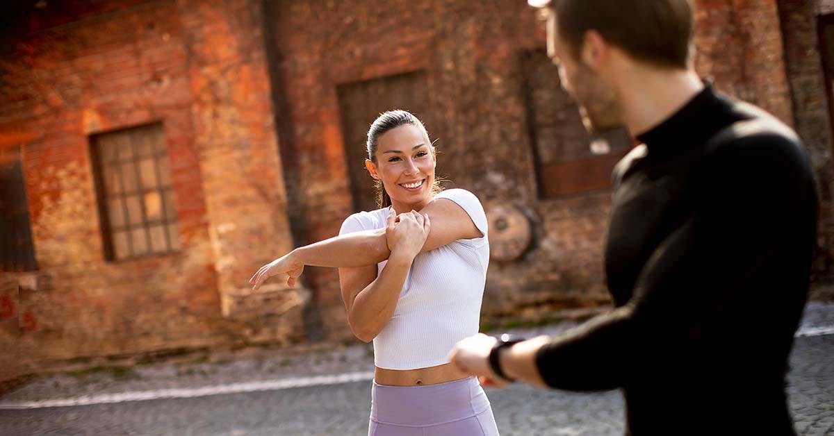 Personal trainer and client outdoors