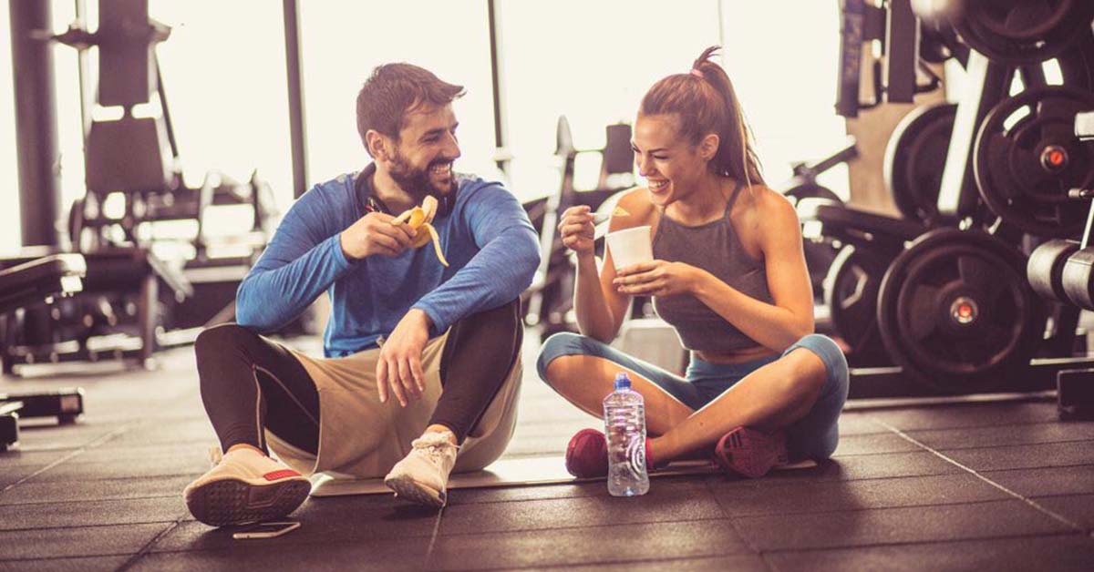 Couple eating a snack at the gym