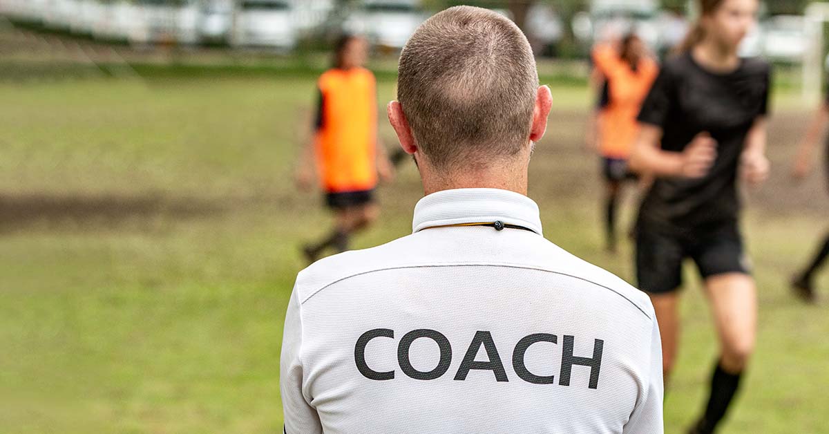 Back view of a soccer coach