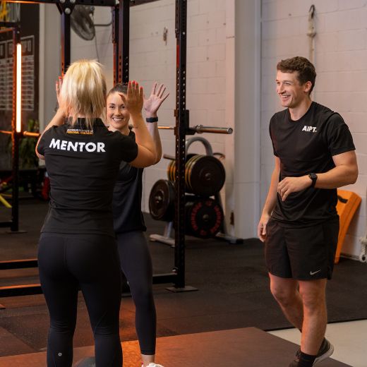 personal trainer and clients at the gym