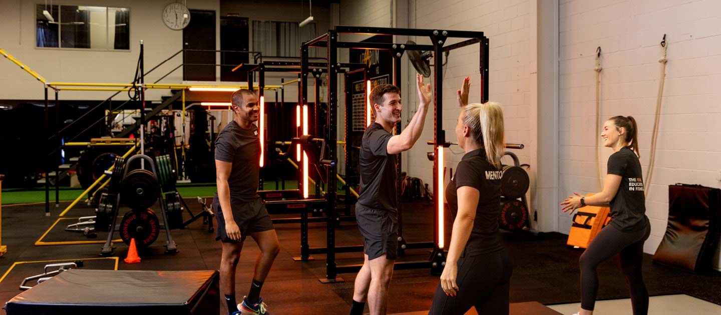 group high fiving in a gym