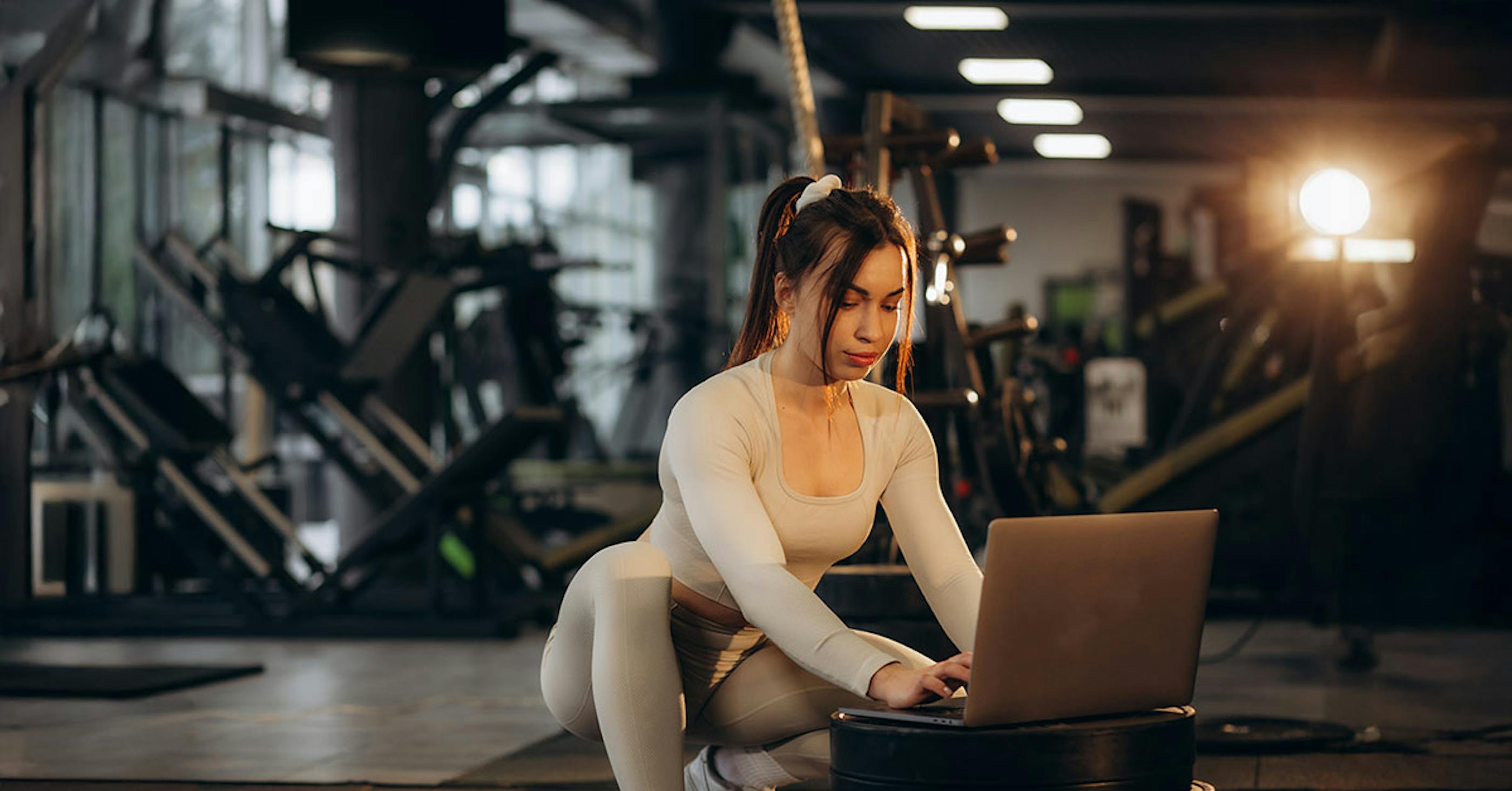 PT typing client notes on laptop