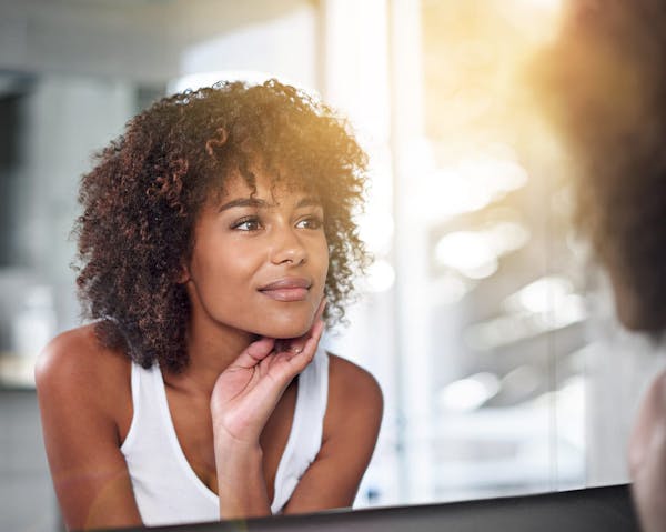 woman looking in mirror