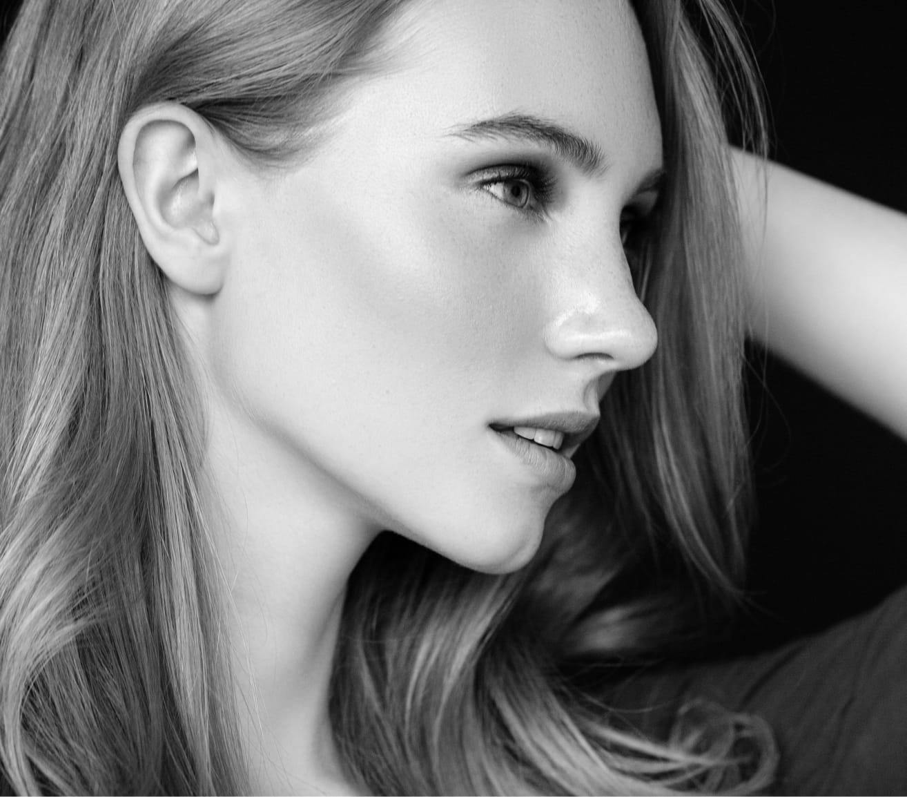 Beautiful woman with clear skin looking to the side