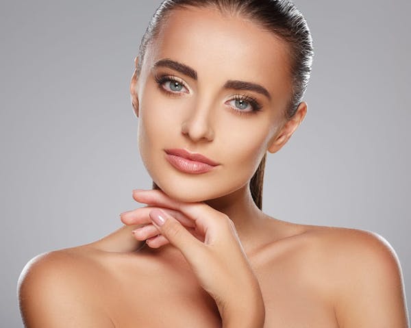 woman with green eyes touching chin