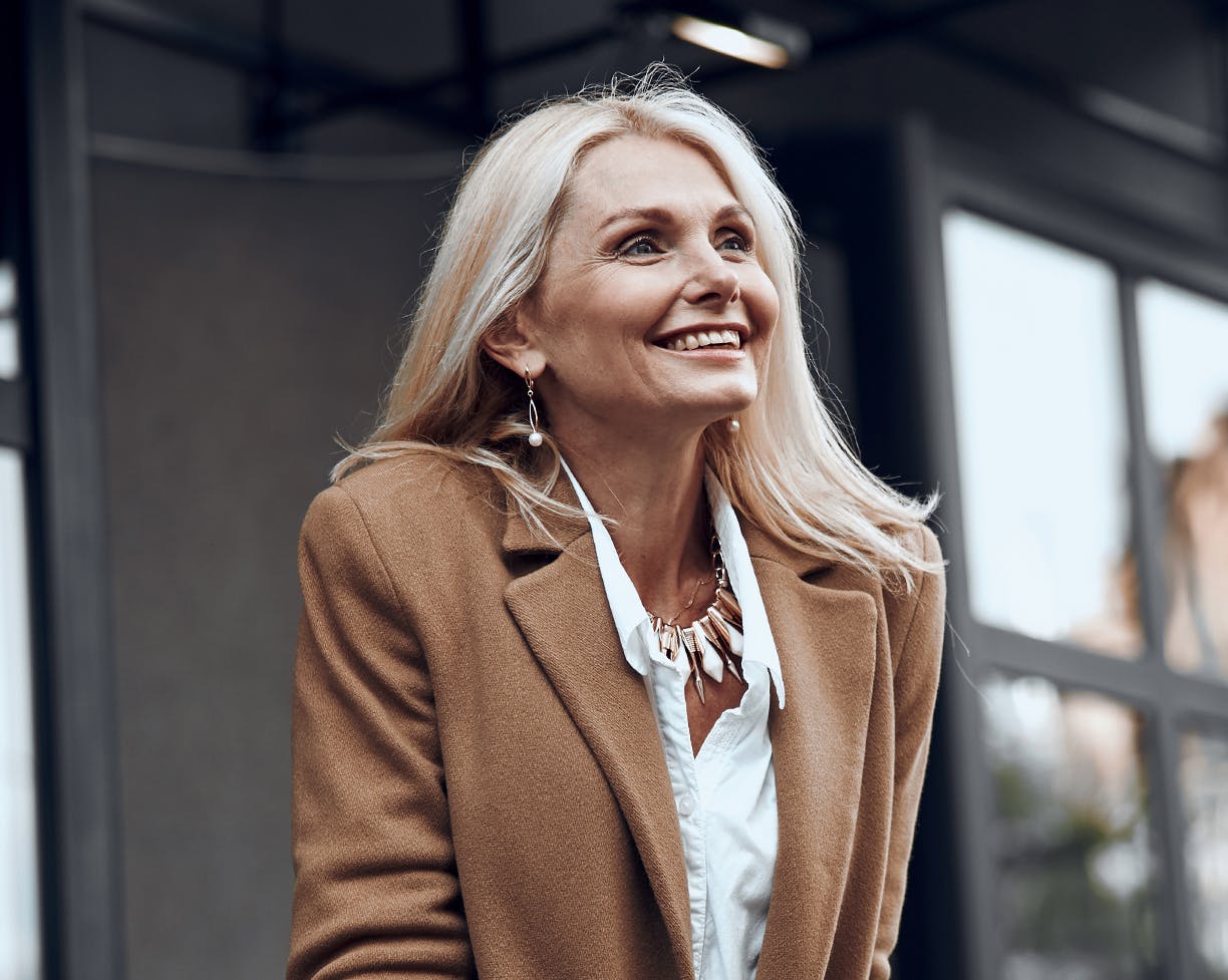 woman with white hair in a coat