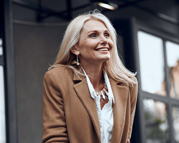 woman with white hair in a coat
