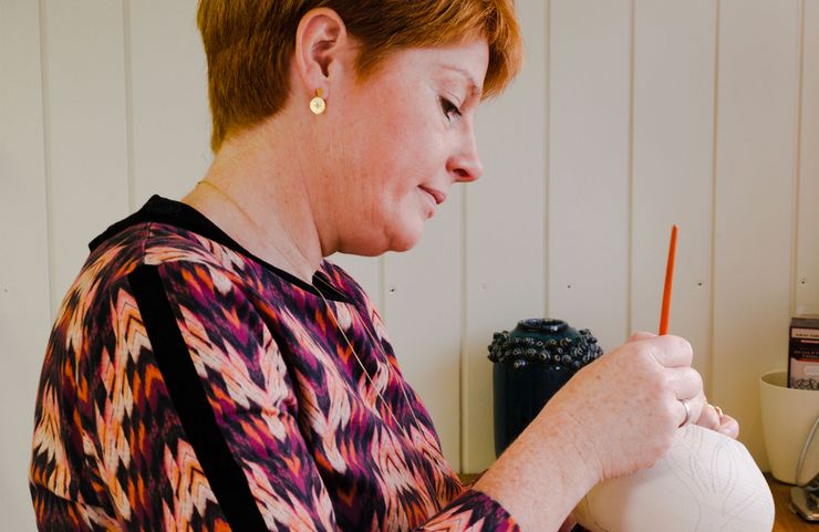 Lisbeth working on a vase in her workshop