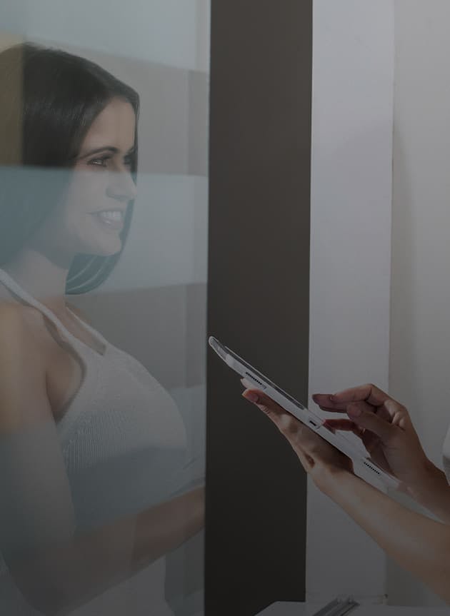 an employee holding an ipad talking to a new patient