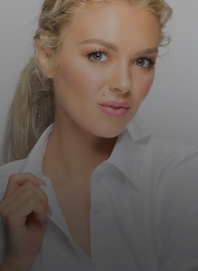 blonde model with light makeup in a white button down shirt