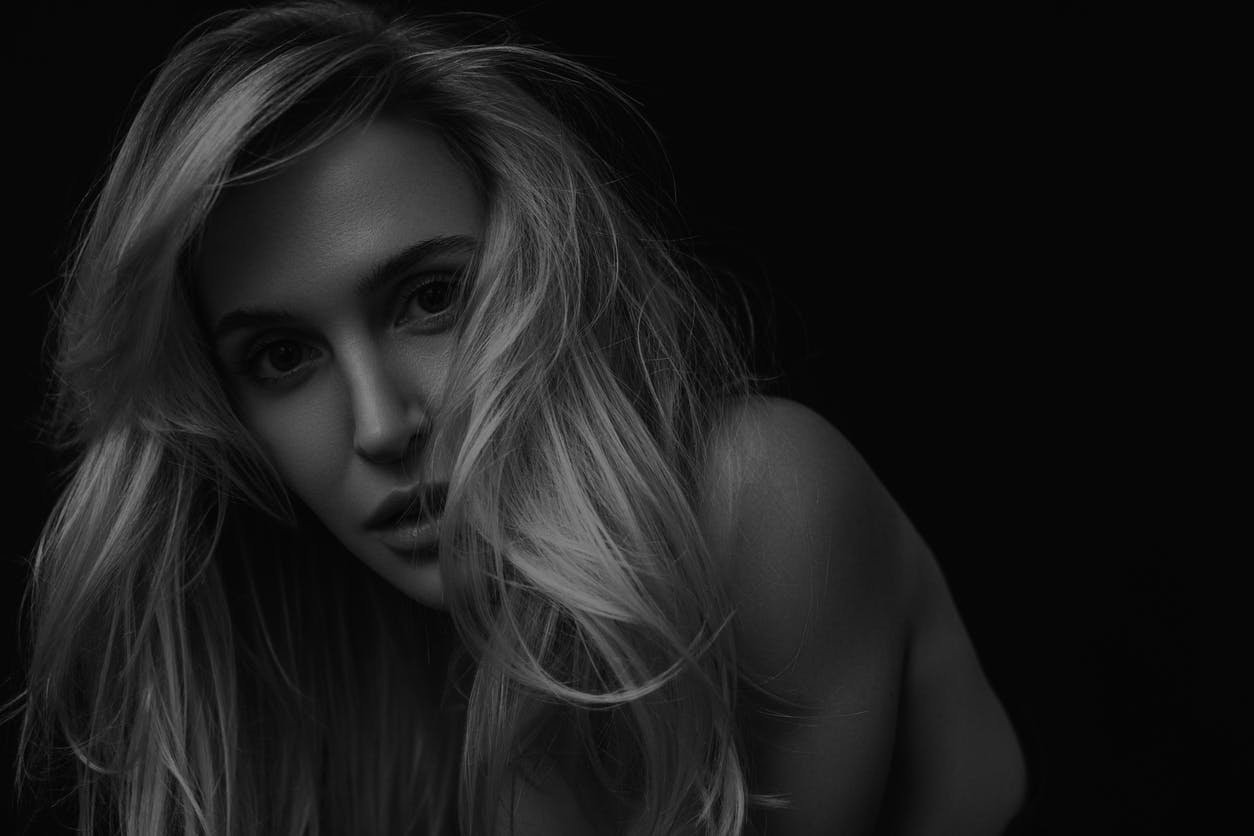 Beautfiul woman with long blonde hair looks at the camera in a studio shoot. Her wrinkle free face shows the potential results of BOTOX in Fort Lauderdale with Dr. Shuster