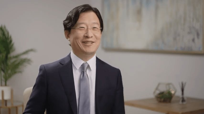 an image of Richard. H Lee wearing a suit doing an interview