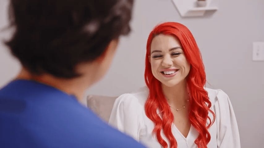 Dr. Lee talking with patient with long bright red hair