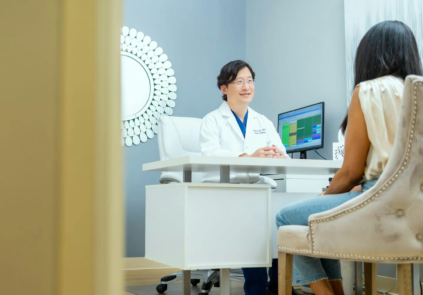 Dr. Lee talking to a patient in his office