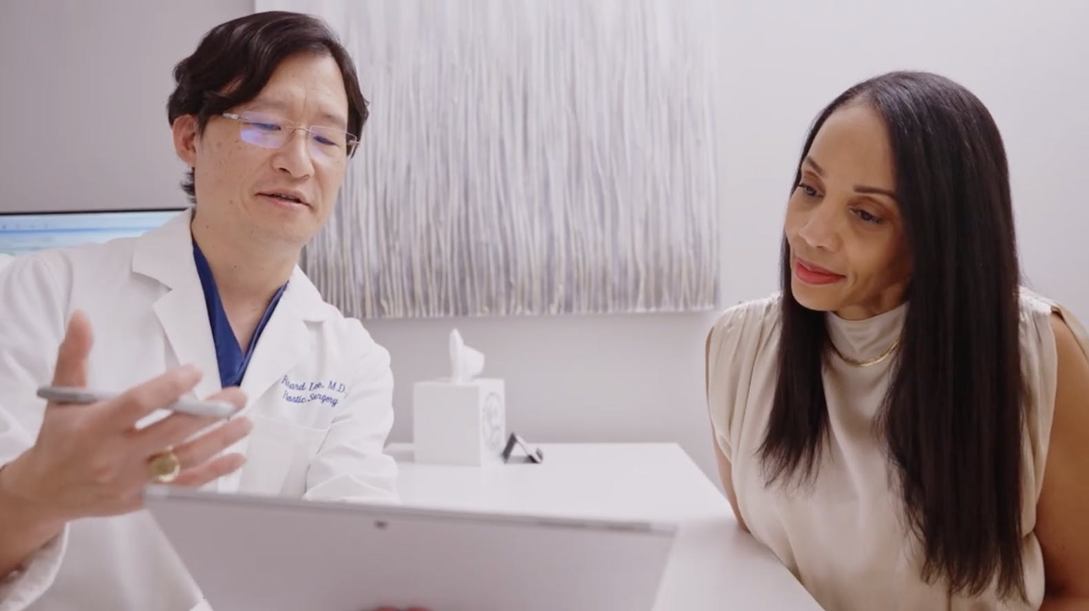 Dr. Lee with a patient doing a consultation for her procedure