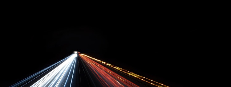 low exposure photo of cars on road during night time