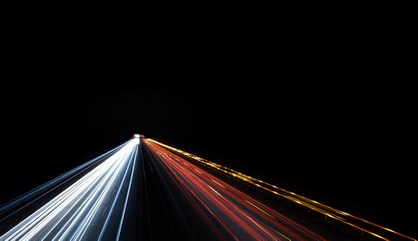 low exposure photo of cars on road during night time