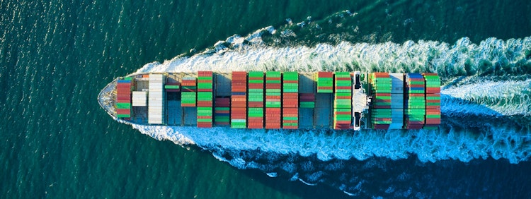 aerial view of blue and white boat on body of water during daytime