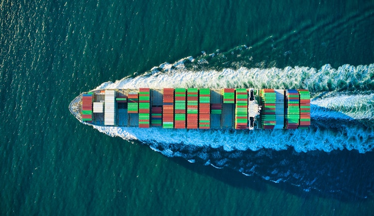 aerial view of blue and white boat on body of water during daytime