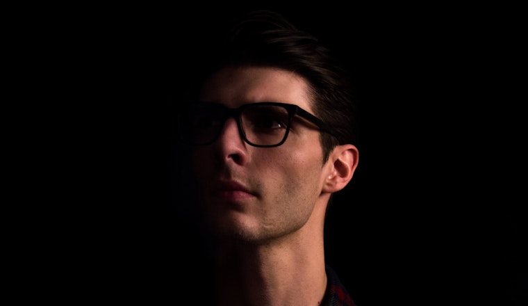 man with glasses looking up