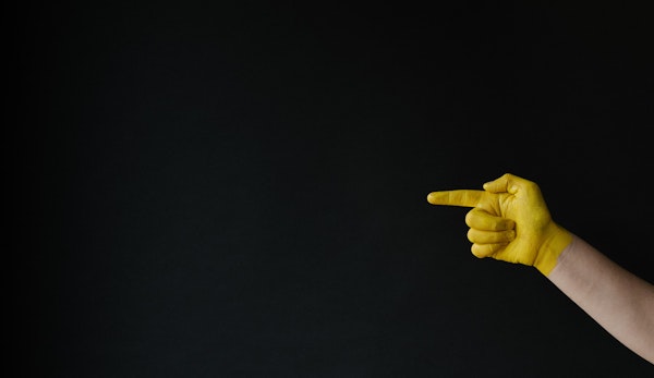 person holding up middle finger