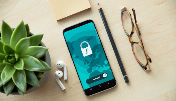 black iphone 5 beside brown framed eyeglasses and black iphone 5 c