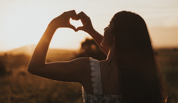 woman forming heart with her both hands