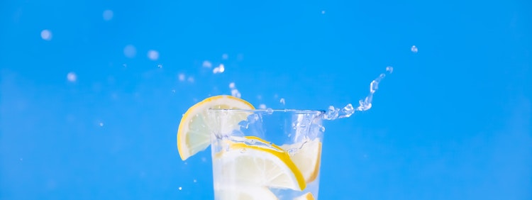 clear drinking glass with yellow liquid