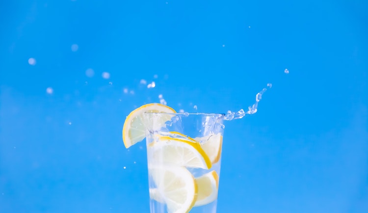 clear drinking glass with yellow liquid