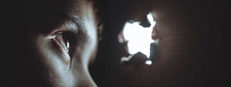 person watching through hole