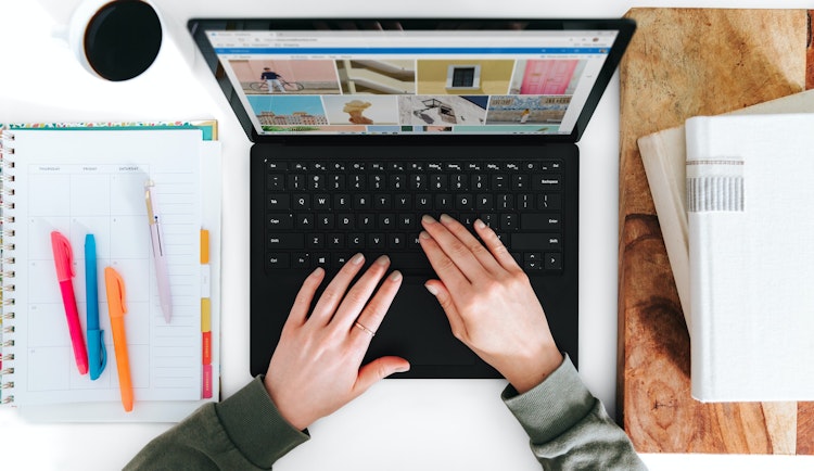 person using Microsoft Surface Laptop black laptop