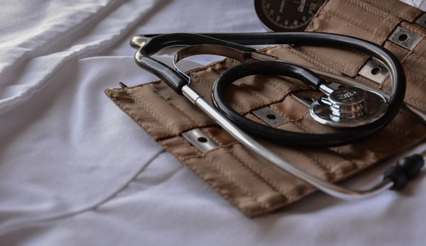black stethoscope with brown leather case