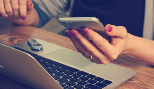 woman holding silver iPhone 6