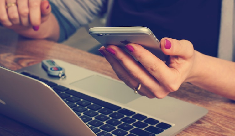 woman holding silver iPhone 6