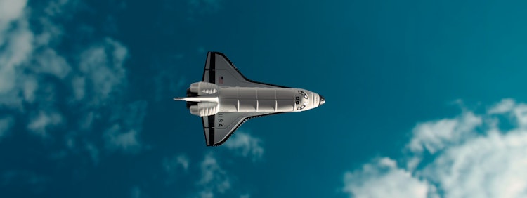 white and black jet plane in mid air under blue sky during daytime